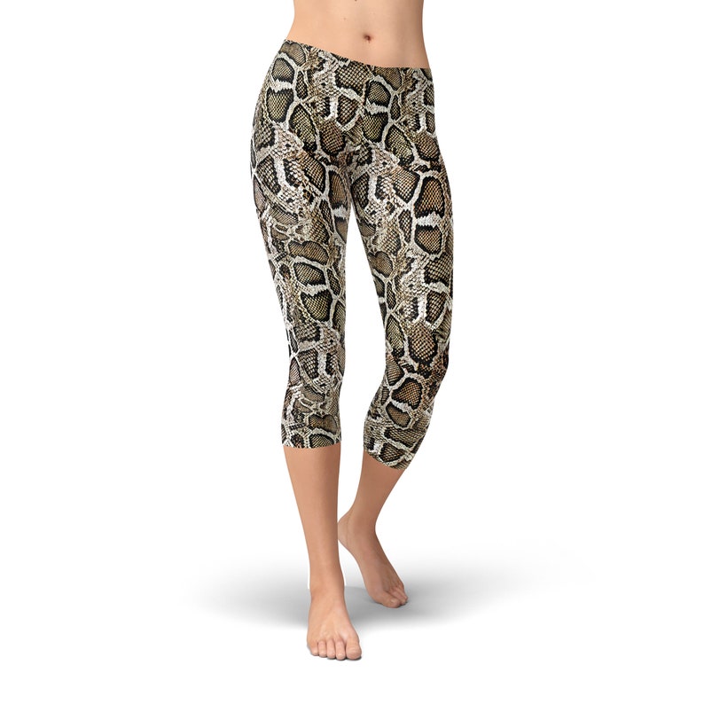 May include: Cropped leggings with a brown and beige snake skin pattern.