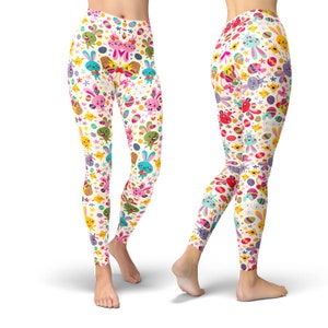 May include: White leggings with a colourful Easter pattern featuring bunnies, eggs, and chicks. The pattern is repeated throughout the leggings.