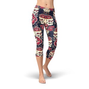 May include: Black leggings with a skull and rose pattern. The skulls are white with black eyes and are surrounded by red roses.