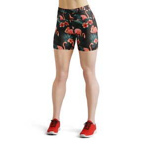 May include: Black athletic shorts with a tropical print featuring pink flamingos and green leaves.