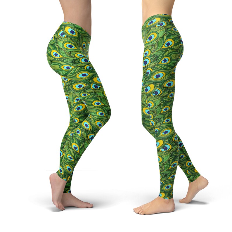 May include: Green leggings with a peacock feather pattern. The pattern features green, blue, and yellow colors.