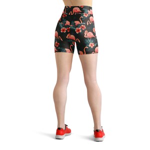 May include: Black athletic shorts with a tropical print featuring pink flamingos and green leaves.