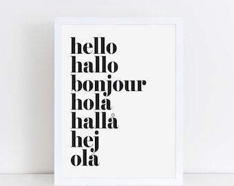 May include: A framed print with the word "hello" in bold black font, followed by "hallo", "bonjour", "hola", "hallå", "hej", and "olá". The words are stacked vertically on a white background.