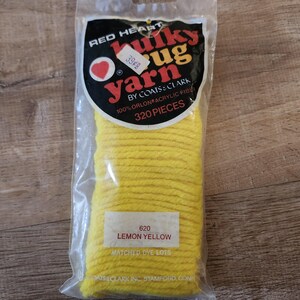 May include: A package of Red Heart Bulky Rug Yarn by Coats & Clark in lemon yellow. The clear plastic bag contains 320 pieces of 100% Orlon acrylic fiber. A white label on the front displays the color name 620 Lemon Yellow and Matched Dye Lots.