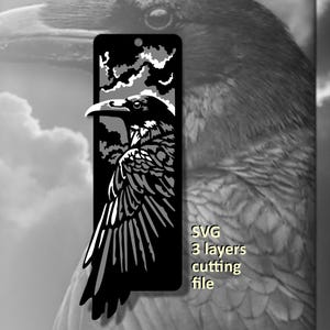 May include: A rectangular black and white bookmark featuring a detailed raven silhouette design with layered cutouts. The graphic depicts a bird against a cloudy sky. The text SVG 3 layers cutting file is printed in yellow on the right side.