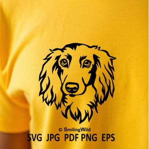 May include: A bright yellow t-shirt featuring a black graphic illustration of a long-haired dog's face. Below the dog, the text reads "&copy; SmilingWild SVG JPG PDF PNG EPS" in black, sans-serif lettering, centred on the fabric.