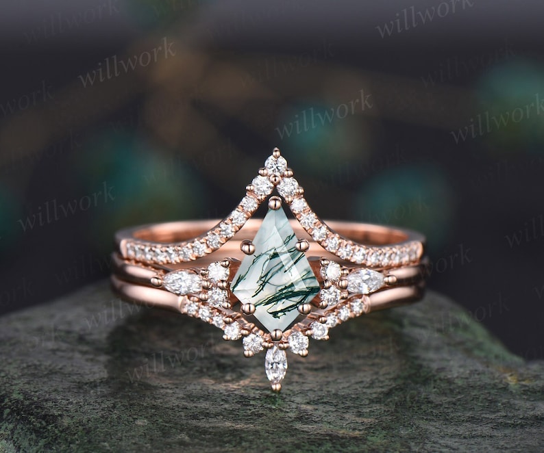 May include: Rose gold engagement ring set with a green moss agate center stone and diamond accents. The center stone is a kite shape and the band is a delicate pave setting.