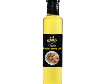 May include: A glass bottle of Giorgio Truffle Oil, labeled "Organic Black Truffle Oil" with a black background and a picture of truffle shavings. The bottle is 250ml.