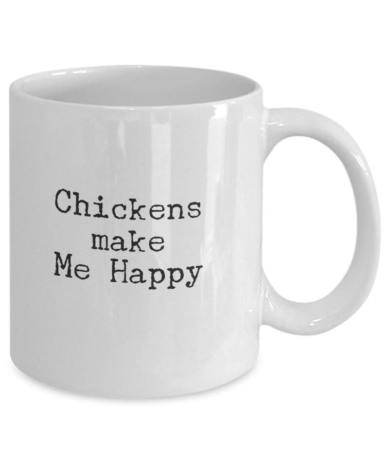 May include: White ceramic coffee mug with black text that reads "Chickens make Me Happy".