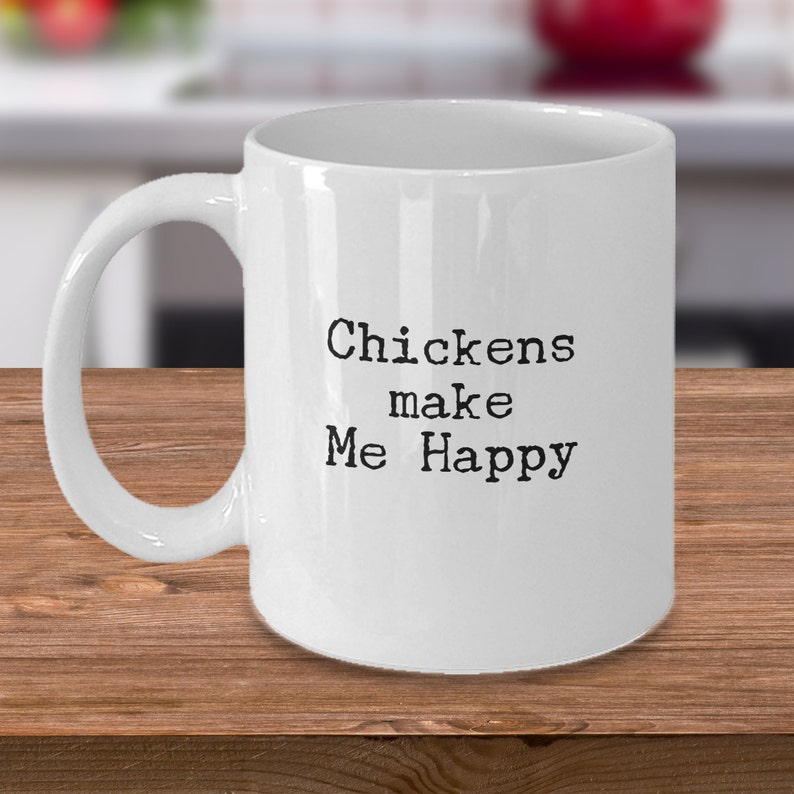 May include: White ceramic coffee mug with black text that reads "Chickens make Me Happy".
