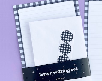 May include: A letter writing set with black and white gingham patterned paper and envelopes. The set includes stickers with the same gingham pattern. The packaging has the text "letter writing set" and the brand name "FYURENA".
