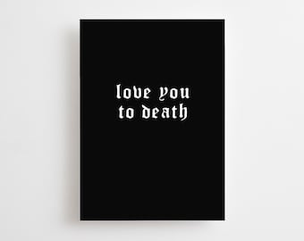 May include: A black rectangular print with the phrase "love you to death" in white gothic font. The print is centered on a white background, creating a stark contrast.
