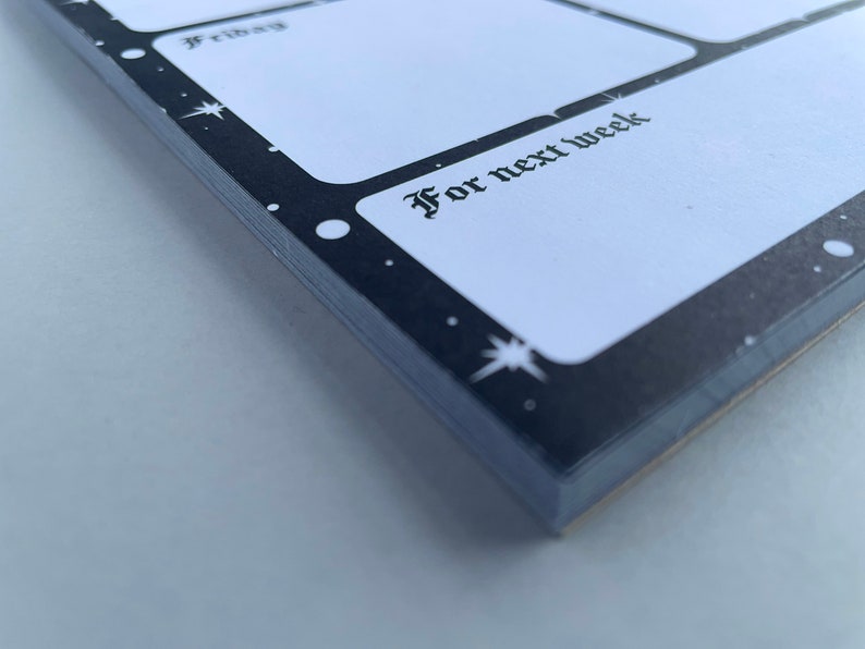 May include: A black and white weekly planner with a star pattern. The planner has a section labeled "For next week".