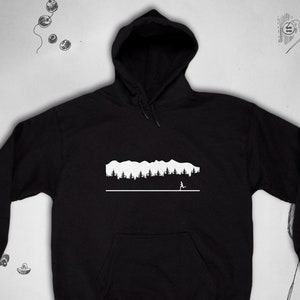 May include: Black hooded sweatshirt with a white graphic of a mountain range and a person running in front of it.