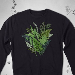 May include: A black sweatshirt with a green floral print of various leaves and ferns.