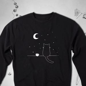 Black cat sweatshirt Trendy graphic design with cat looking at the Moon Cute funny unisex crewneck sweatshirt Cat lover gift idea