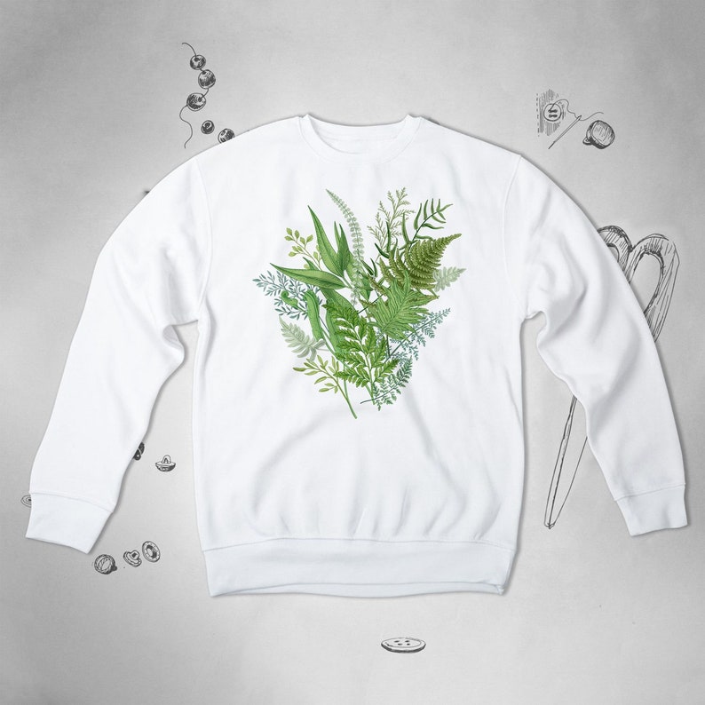 May include: White sweatshirt with a green leafy botanical print on the front.