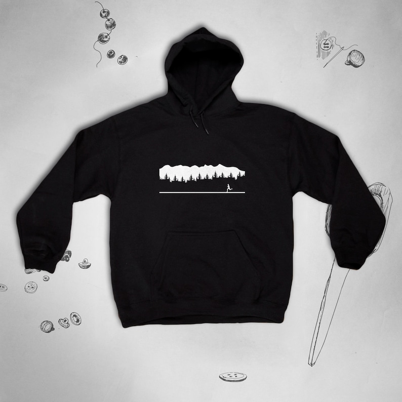 May include: Black hooded sweatshirt with a white graphic of a mountain range and a person running in front of it.