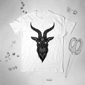 May include: White t-shirt with a black and white illustration of a goat's head with horns and a pentagram on its forehead.