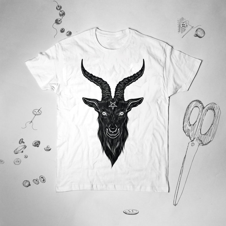 May include: White t-shirt with a black and white illustration of a goat's head with horns and a pentagram on its forehead.