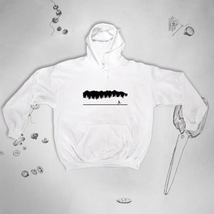 May include: White hooded sweatshirt with a black silhouette of a forest and a person running away from it.