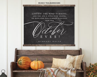 May include: A rustic wooden bench is adorned with pumpkins, pillows, and a plaid throw. Above, a chalkboard-style sign displays the text "October Eves!" by Humbert Wolfe, creating a cozy autumn scene. Black lanterns and a basket of flowers complete the decor.