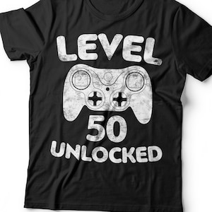 May include: Black t-shirt with a white graphic of a video game controller and the text "LEVEL 50 UNLOCKED".