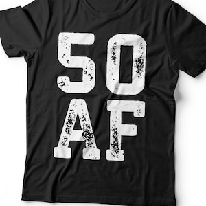 May include: Black t-shirt with the text "50 AF" in distressed white lettering. The shirt is a classic crew neck style, suitable for casual wear. The bold graphic design is centered on the front of the shirt.