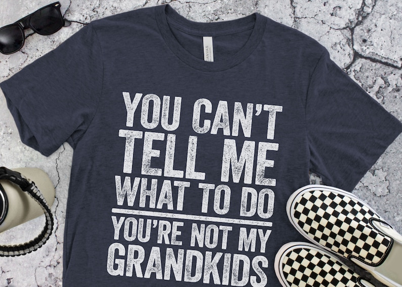 May include: A navy blue t-shirt with a white distressed graphic that reads "You can't tell me what to do you're not my grandkids".