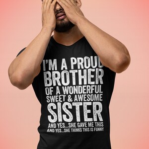 Puede incluir: Una camiseta negra con texto blanco que dice "Soy un hermano orgulloso de una hermana maravillosa, dulce y genial y s&iacute;...ella me dio esto y s&iacute;...ella piensa que esto es gracioso."