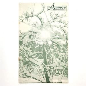 May include: A vintage magazine cover featuring a snowy forest scene with the word "Ascent" printed in a cursive font.
