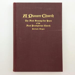May include: A maroon book with gold lettering. The title reads "A Pioneer Church" and the text below states "The First Seventy-five Years of the First Presbyterian Church, Portland, Oregon."