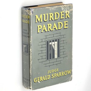 May include: A vintage hardcover book titled "Murder Parade" by Judge Gerald Sparrow. The cover features a brick wall with a barred window and a noose hanging from the ceiling.