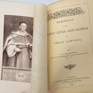 May include: A black and white portrait of a man in a robe with a large collar. The text below the portrait reads "Sir Matthew Hale, Lord Chief Justice His Majesty's King's Bench". The title of the book is "Memorials of the Early Lives and Doings of Great Lawyers" by C.L. Brightwell.