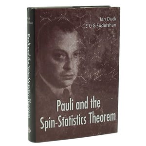 Peut inclure: Livre intitulé "Pauli and the Spin-Statistics Theorem" par Ian Duck et ECG Sudarshan. La couverture est marron foncé avec un portrait et des schémas scientifiques. La tranche est noire avec le titre.