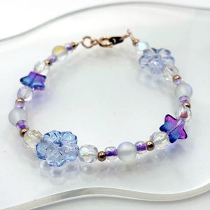 Handmade Huntrix inspired bracelet with glass beads. Approximately 7.5” long with a rose gold clasp