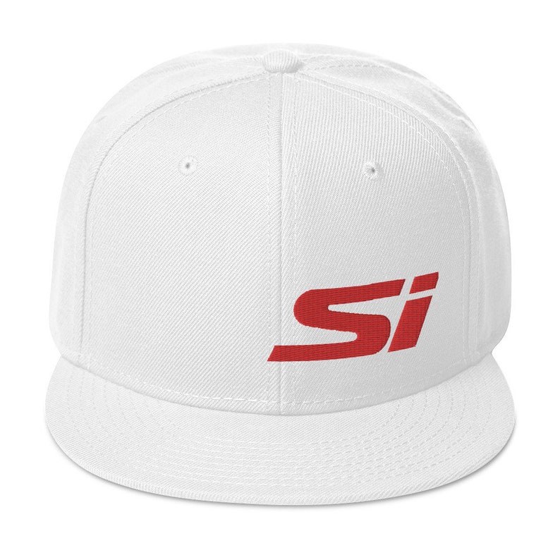 May include: A white baseball cap with a flat brim. The cap features the red letters "SI" embroidered on the front. The hat is made of a durable fabric and has a structured fit.