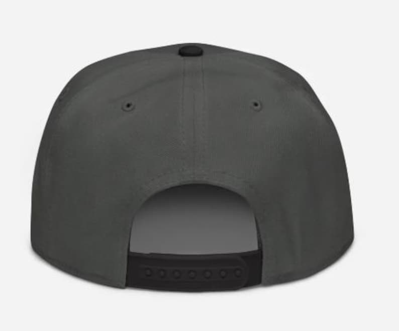 May include: A dark gray baseball cap with a flat brim and a black adjustable snap closure. The cap has a structured crown and a small black button on top. The back of the cap is open.
