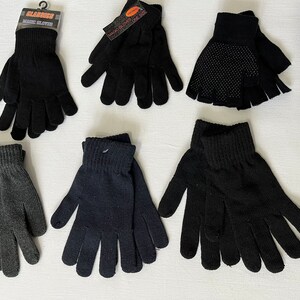 May include: Assortment of six pairs of gloves in black and gray. The gloves are made of a soft, knitted fabric. Some gloves are fingerless, while others are full fingered.