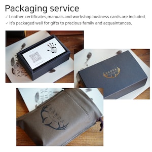 May include: A brown leather pouch with a gold logo that says "BANDA" and a stylized deer antler design. The pouch is sitting on a wooden surface.