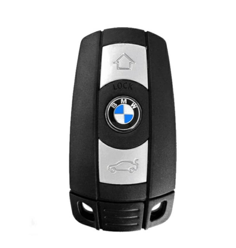 Puede incluir: Llavero de coche negro con un bot&oacute;n plateado y un logotipo de BMW. El bot&oacute;n dice "LOCK".