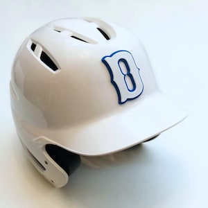 May include: White baseball helmet with a blue and white letter "B" on the side.