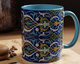 May include: A blue ceramic mug with a colorful geometric pattern. The mug has a white rim and a handle.