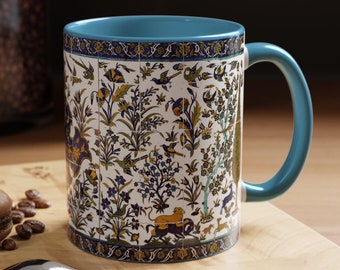 May include: A blue and white ceramic mug with a floral pattern. The mug has a blue handle and a white interior. The pattern includes flowers, birds, and geometric designs.