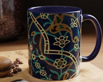 May include: A blue ceramic coffee mug with a colorful floral pattern. The mug has a handle and is sitting on a wooden surface.