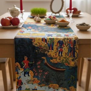 May include: A patterned table runner featuring a detailed illustration of figures in traditional dress, a boat, and floral designs. The runner is laid on a wooden table, adorned with apples, candles, and small bowls. The runner's design is predominantly blue and yellow.