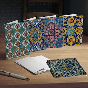 May include: Set of five greeting cards featuring intricate blue, yellow, and green geometric patterns inspired by traditional Persian tile designs.