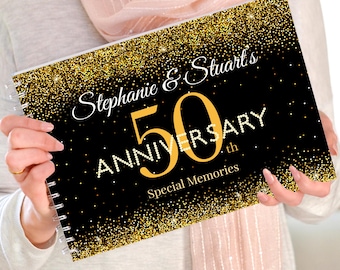 May include: A black and gold glitter scrapbook with the text "Stephanie & Stuart's 50th Anniversary Special Memories".