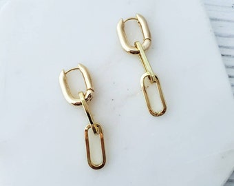 May include: Gold chain link earrings with a hoop design. The earrings are made of two connected links.