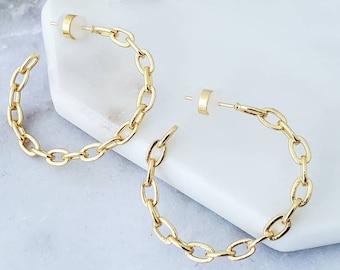 May include: A pair of gold hoop earrings with a chain link design.